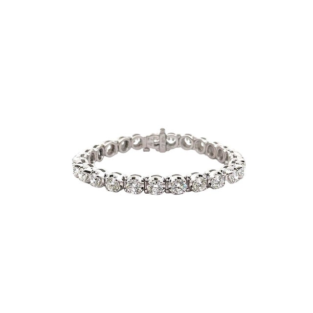 A contemporary tennis bracelet crafted in platinum. The design features round white diamonds, totaling 13.22 carats,...