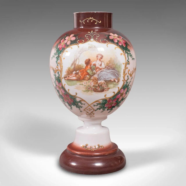 This is an antique decorative flower vase. A Continental, painted milk glass baluster urn, dating to the late Victorian...