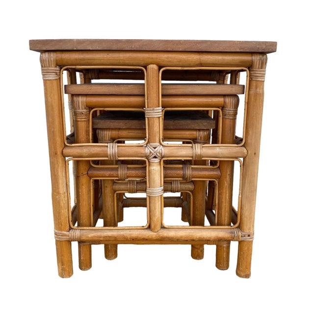 Set of 3 vintage stacking nesting tables are made of bamboo, rattan and wood tabletops. These are in good vintage...