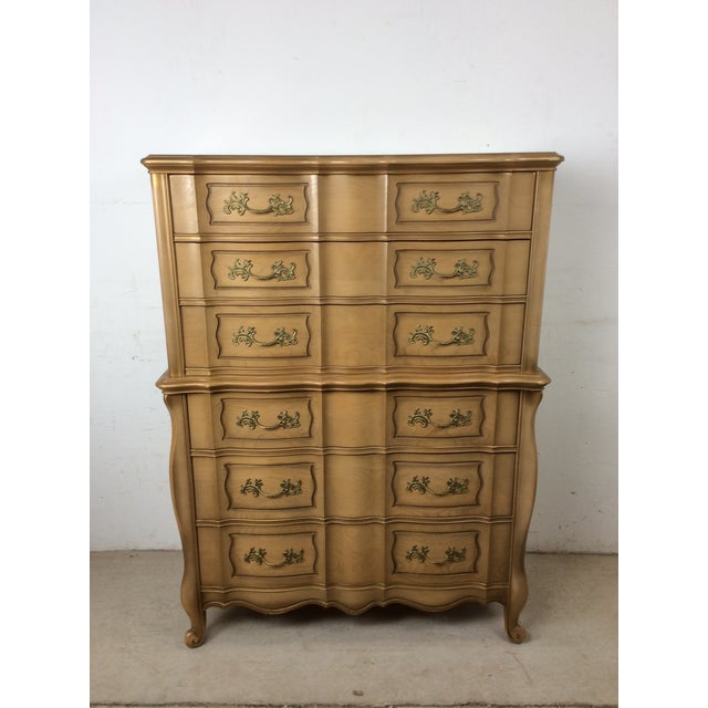 This mid century French Provincial style highboy dresser features hardwood construction, original limed finish, six...