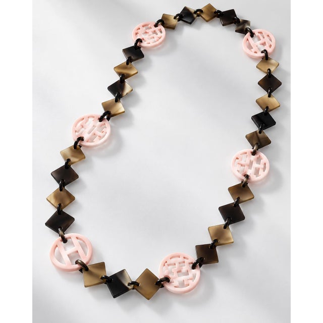 An authentic Hermès statement collar necklace showcasing the maison's iconic combination of natural horn and rich lacquer...