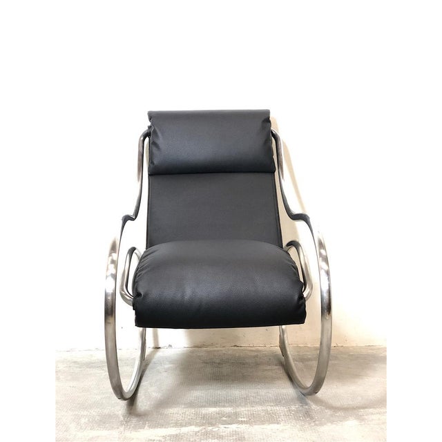 Rocking armchair produced by Heals, London 70s. The armchair is made up of a steel tubular structure and eco -colored...