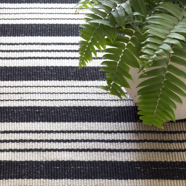 Get the best of both worlds with this durable, washable, and eco-friendly indoor/outdoor rug in a classic black and ivory...