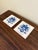 A classic pair of Dutch Delft-style hand painted blue and white porcelain tiles featuring an intricately rendered heraldic...