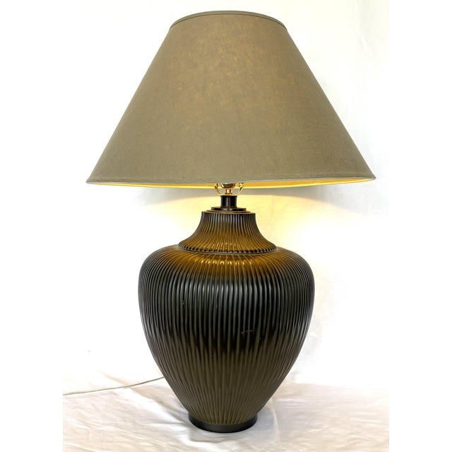 Great mid-century modern large table lamp. It is made of metal with a gourd shape and a pleated or ribbed texture in a...