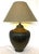 Great mid-century modern large table lamp. It is made of metal with a gourd shape and a pleated or ribbed texture in a...