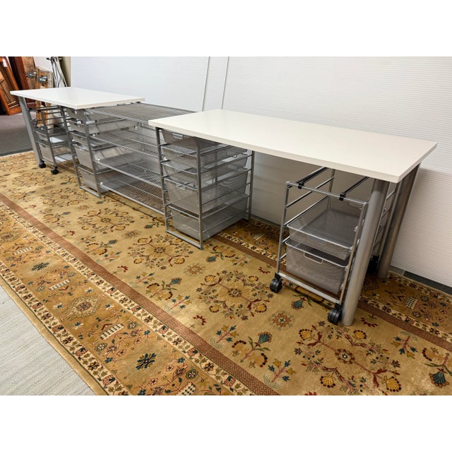 Design Plus Gallery presents a Pair of Elfa Classic Desks with Two Rolling Drawers from The Container Store. The white top...