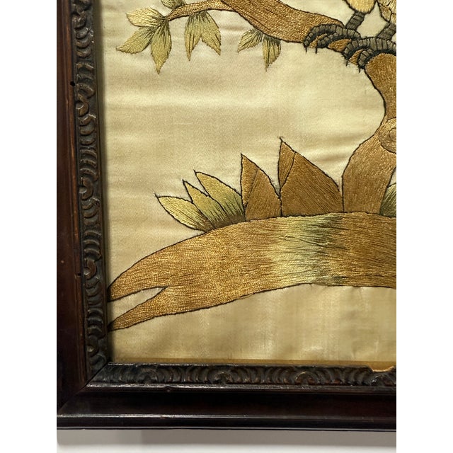 A finely executed antique embroidered silk panel depicting a parrot perched on a branching limb, rendered with strong...