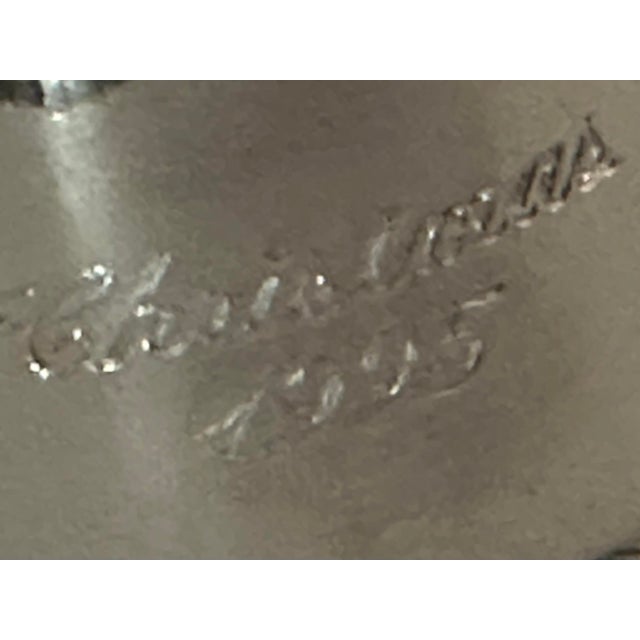 Vintage 1995 silver & gold colored Christmas bell. It has a wreath-shaped handle with a bow and the front is is engraved...