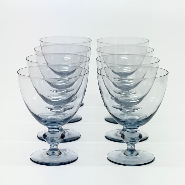 Grey goblet glasses, set of 8. A delicate set of light dove-grey water glasses with a diamond stem detail by Kosta Boda....