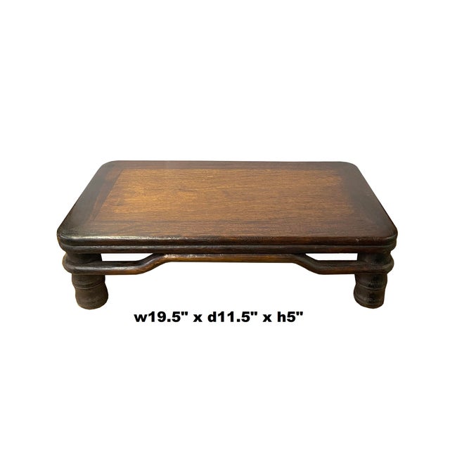 This is a rectangular wood stand with an Oriental simple design and round shape legs as an accent. Dimensions: 19.5" x...