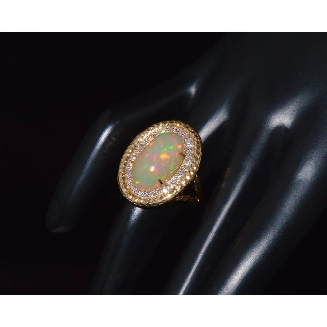 Gorgeous 18K solid gold 0.38CTS natural diamond and 7.06CTS natural opal cocktail ring. This ring features a huge natural...