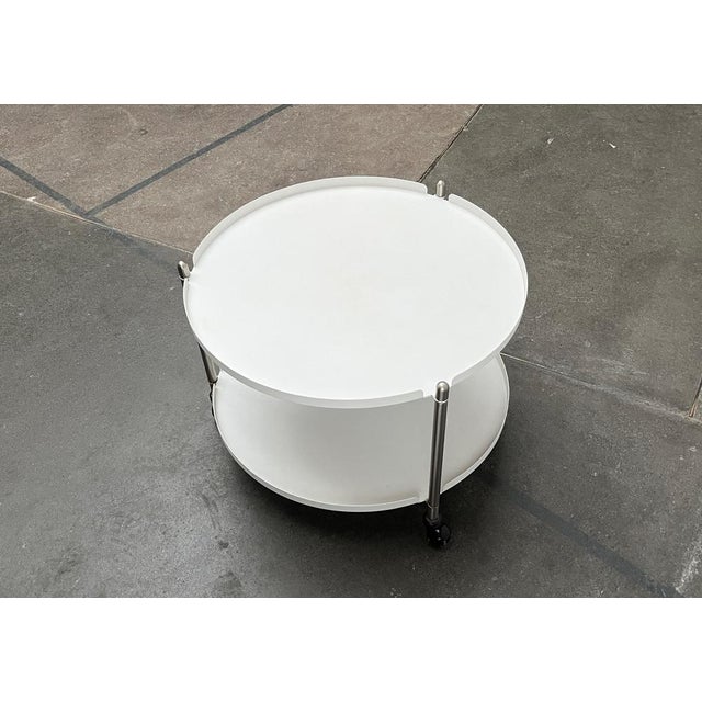 Simple metal side table on castors from Leitmotiv. A minimalist design. The two tray-shaped shelves are made of steel and...