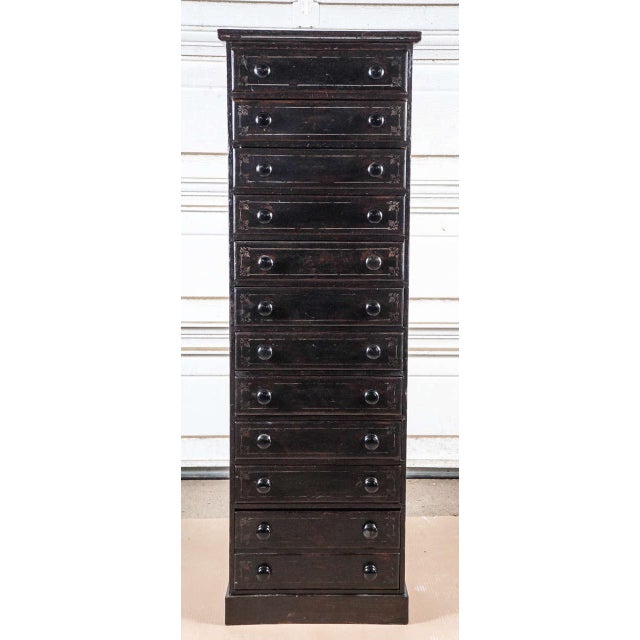 English painted pine eleven-drawer tall chest. Small pull-out shelf above the fourth drawer from the bottom drawer is...