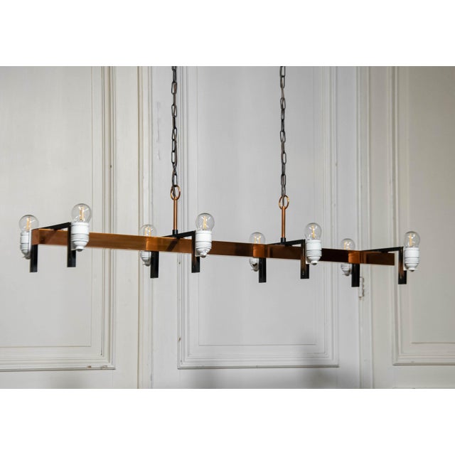 Beautiful 1970s horizontal copper chandelier attributed to Jo Hammerborg for Fog & Mørup Denmark. The eight glass shades...