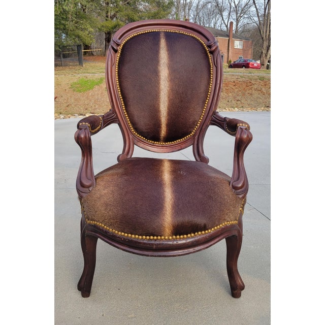 Antique Louis XVI oval back chair with gorgeous carved frame, reupholstered in silken cowhide with a narrow white blaze...