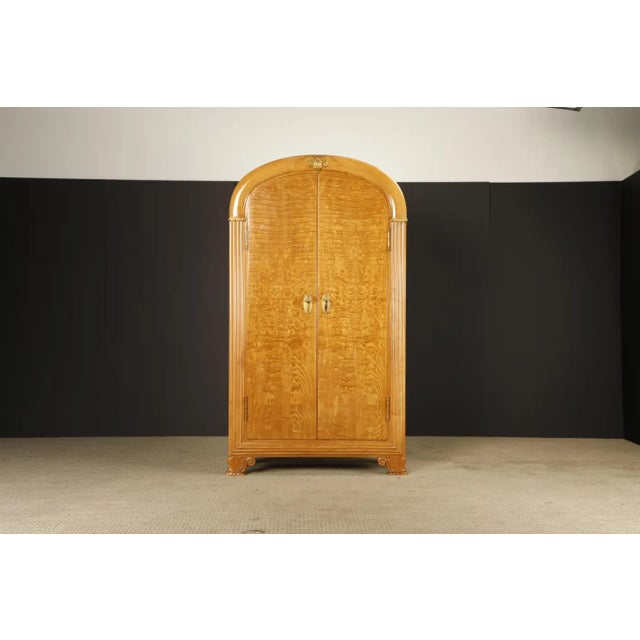 This extraordinary monumental armoire showcases a rare blend of late Art Deco sophistication and Hollywood Regency...