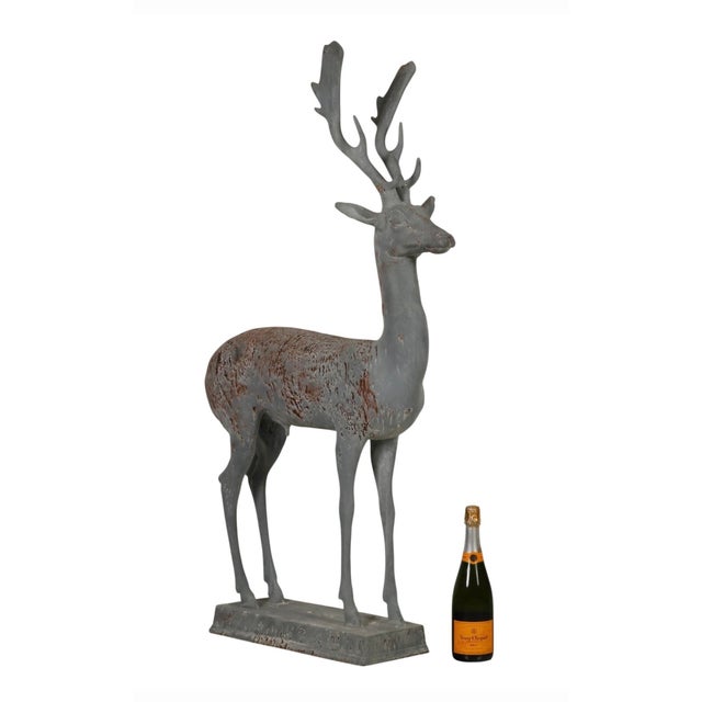 An exceptional and stately vintage cast lead garden sculpture of a standing stag, exhibiting a beautifully proportioned,...
