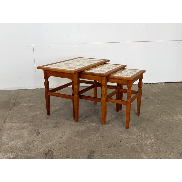 Solid oak and ceramic tile-top nesting tables by Henning Kjærnulf, Denmark, 1960s. Each top is inset with a grid of hand-...