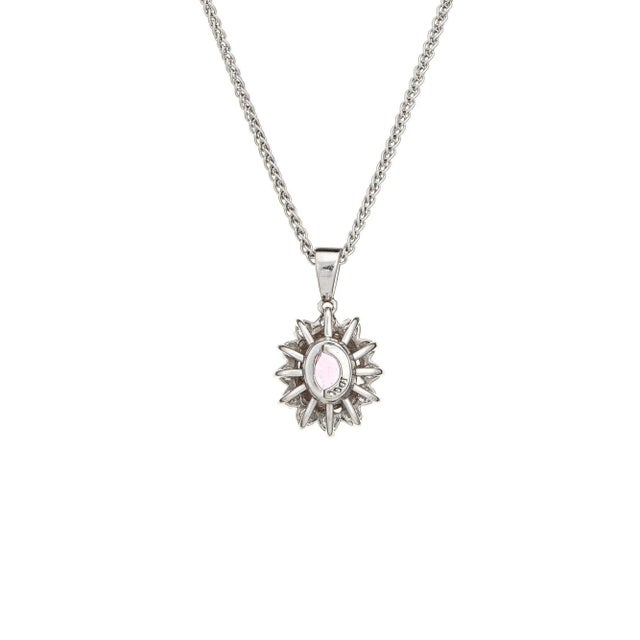 Stylish natural pink sapphire & diamond necklace crafted in 18 karat white gold (circa 1990s). Oval shape mixed cut...