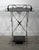 This early 20th century French folding steel table has the right bones for the form: an X-base frame, a tray top with...