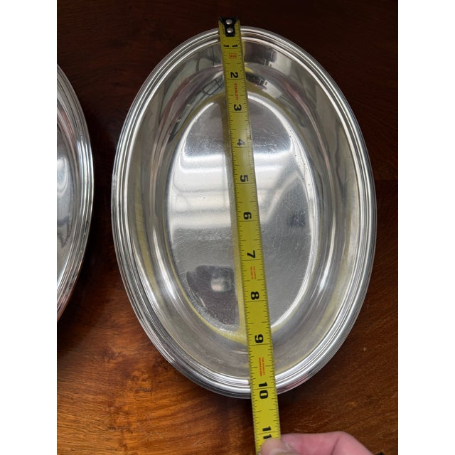 For your dining table or sideboard, a beautiful pair of oval silver soldered serving dishes by Tiffany & Company. Tiffany...