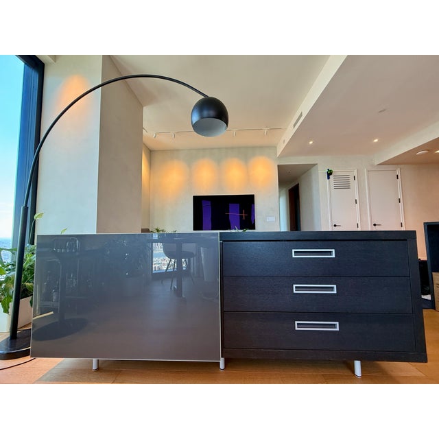 A modern classic - grey wood sideboard with 3 drawers and sliding smoke glass door (1 shelf) Legs can be adjusted for...