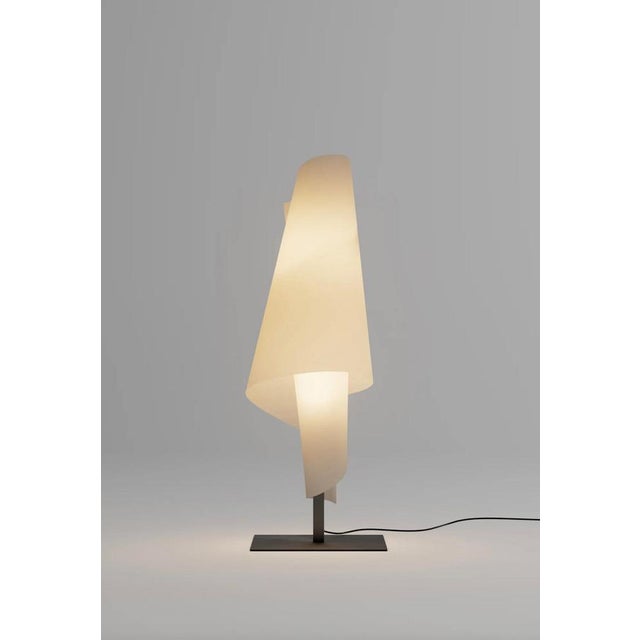Josep aregall talla 3 table lamp for parachilna talla 3 is a lamp composed of a diffuser that wraps around a steel mast...