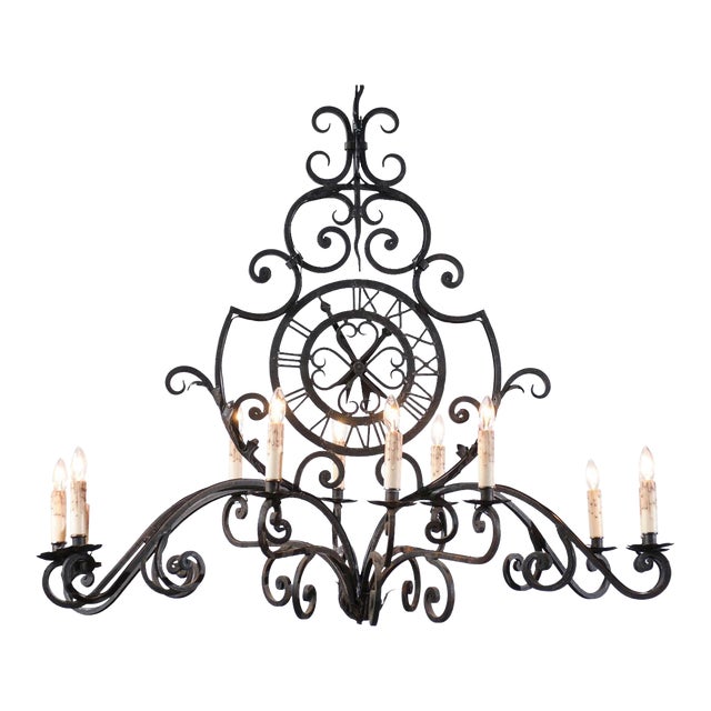 Early 20th Century French 12-Light Wrought-Iron Chandelier with Clock Motif and Scrolling Armature For Sale
