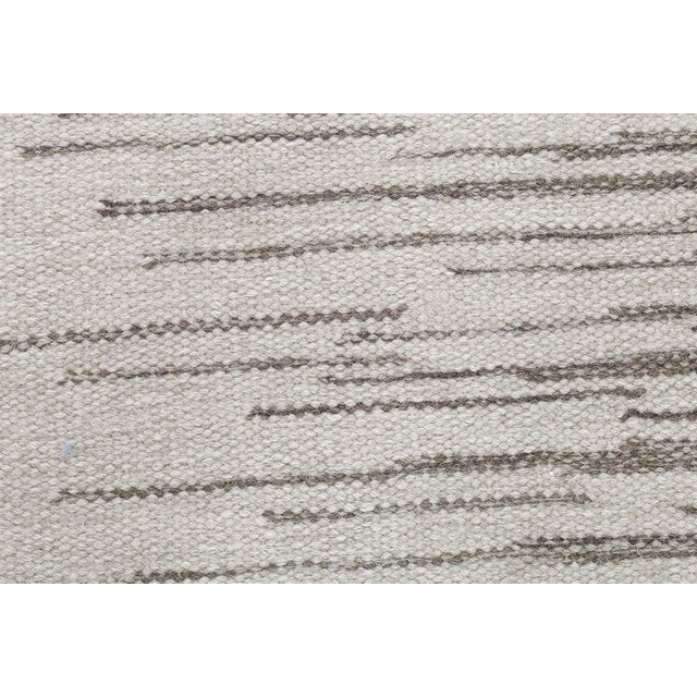 This Modern Swedish Flat-Weave Rug exemplifies the Scandinavian tradition of understated elegance and functional design....