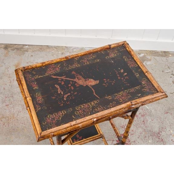 This 19th-century rectangular bamboo side table features a black lacquered top, framed by bamboo trim with a textured...