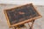 This 19th-century rectangular bamboo side table features a black lacquered top, framed by bamboo trim with a textured...