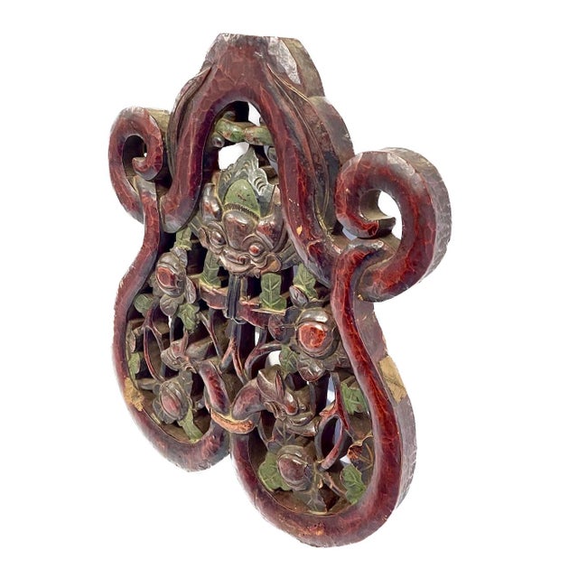 Antique Asian hand-carved dragon and floral wall plaque. Depicts two dragons surrounding floral and leaf design. No...