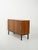 Scandinavian teak sideboard from the 1960s with a side roller door, a compartment with a double shelf, and black metal...