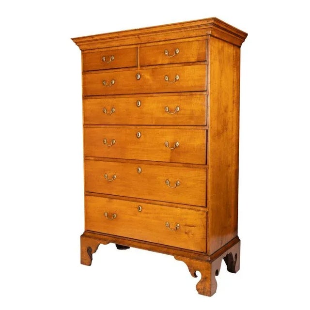American Chippendale maple tray top tall chest with divided top drawer. The chest is mounted with a cornice and rests on...