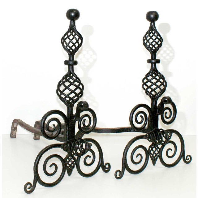 Antique French wrought iron andirons having double birdcage design balusters on scrollwork supports. Circa:1900.