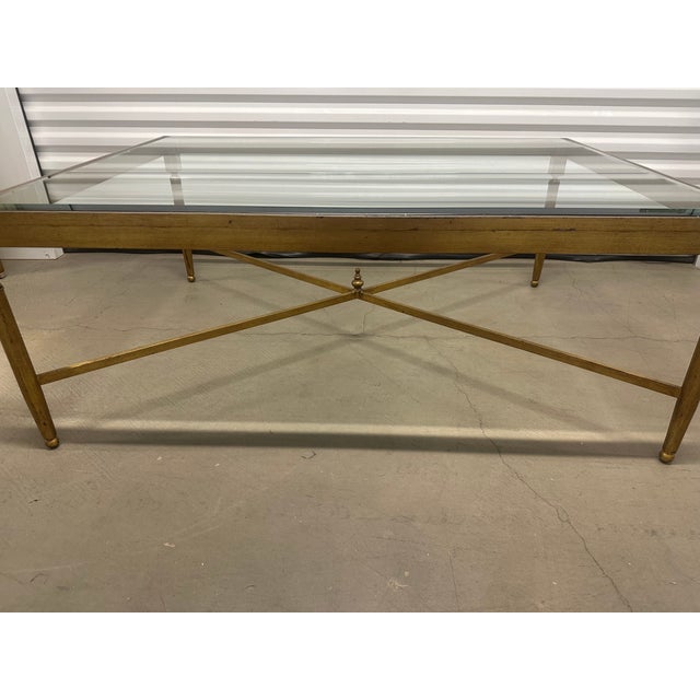 This is a fantastic vintage metal coffee table finished with a burnished gold lacquer. The beveled glass top is in...