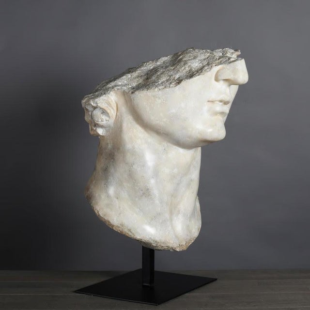 Sculpture of a head of Apollo in the Hellenistic style. Sculpture on base of a head of Apollo, in patinated plaster and...