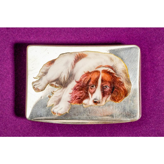 Step into the elegance of the early 20th century with this extraordinary circa 1900 hand-painted enamel and silver snuff...