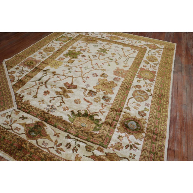 A One of a kind Turkish Oushak rug with olive accent colors on an ivory ground woven with angora wool Measures: 8'2'' x...