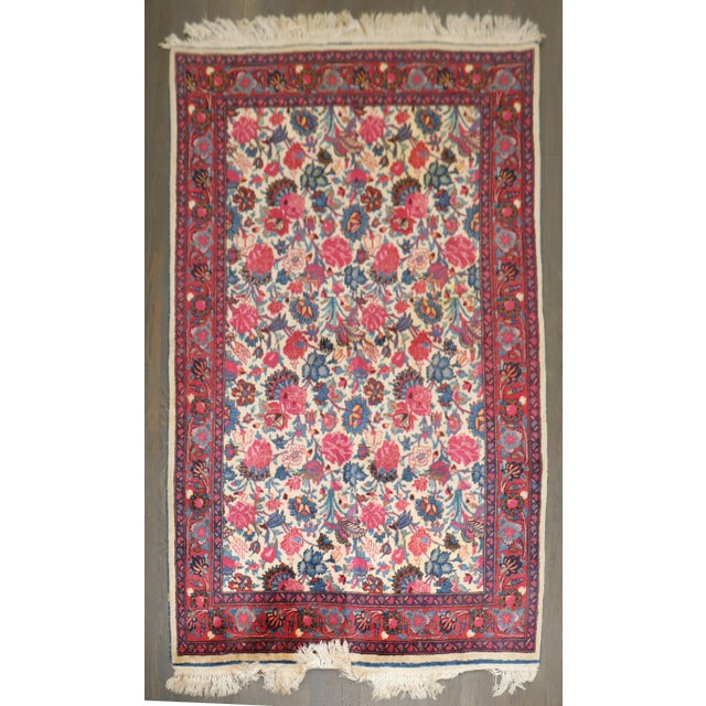 a rare pair of mid 20th Century Ivory field floral design Persian Meshed Rugs each measuring 4' x 6'7''
