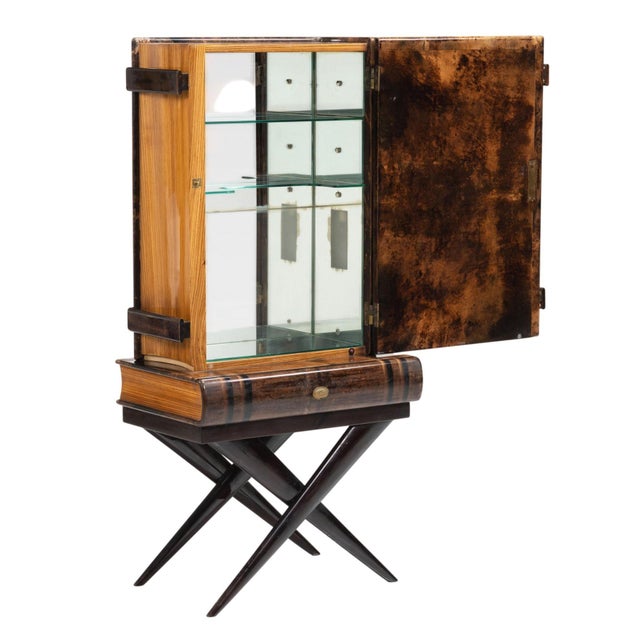 An iconic Mid-Century Modern bar cabinet designed by Aldo Tura, Italy, circa 1950's. Crafted in Tura’s signature lacquered...
