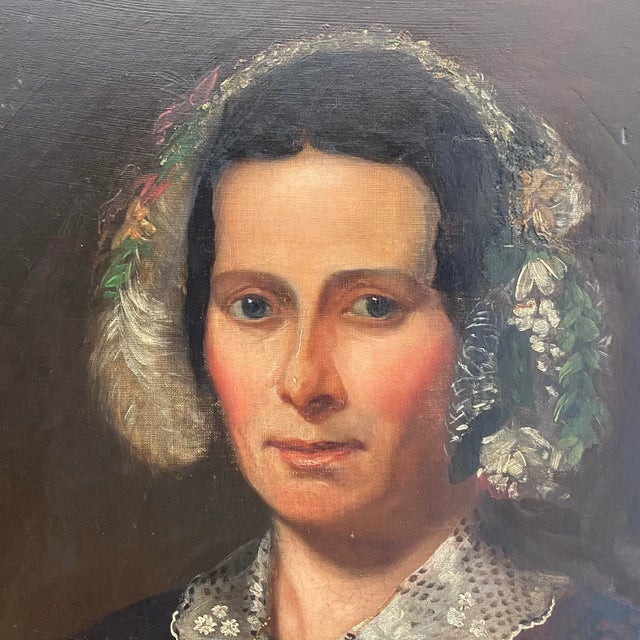 A quietly compelling 19th-century folk portrait, this original oil painting depicts a woman with a direct, introspective...