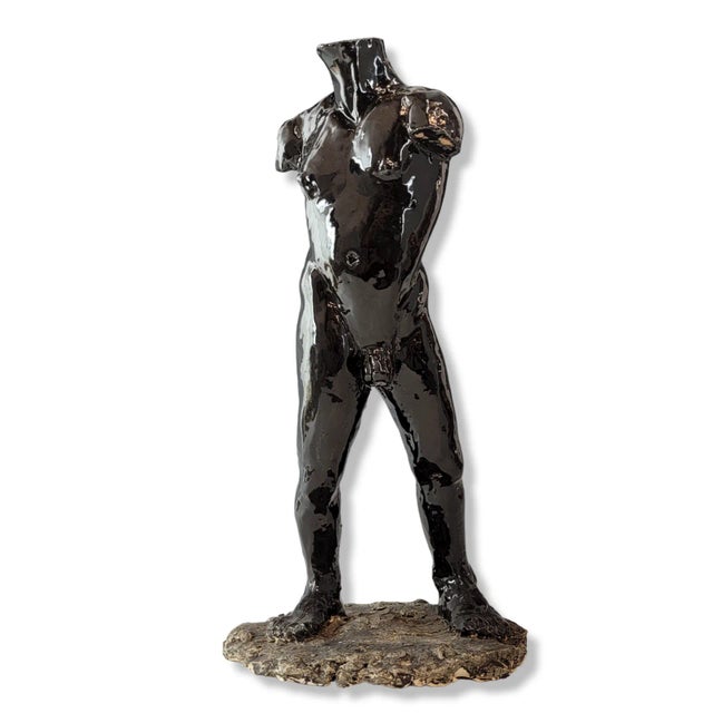 This is a handsome male clay sculpture by Sherri Cavan. The sculpture features a nude male bust made of glazed black clay....