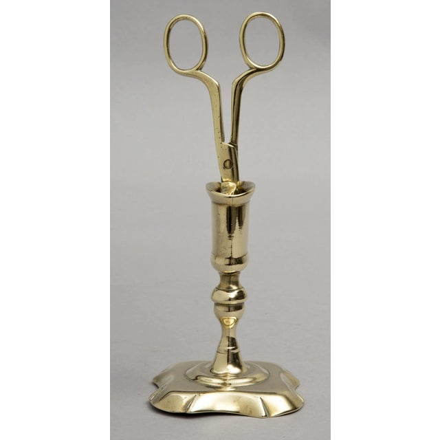 Queen Anne period standing brass candle snuffer with scissors-like handle and pointed tip, two holes in the bottom of the...