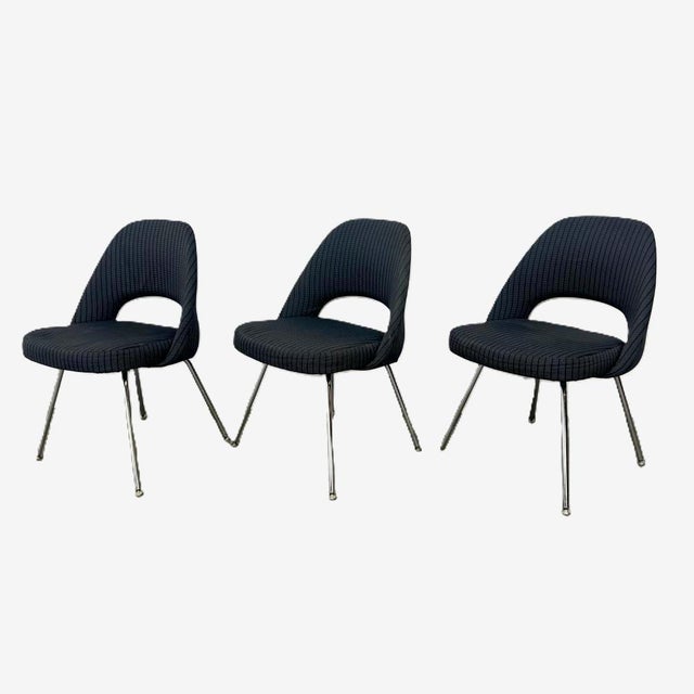 A trio of Knoll Executive armless chairs designed by Eero Saarinen for Knoll. The chairs are upholstered in Knoll Textiles...