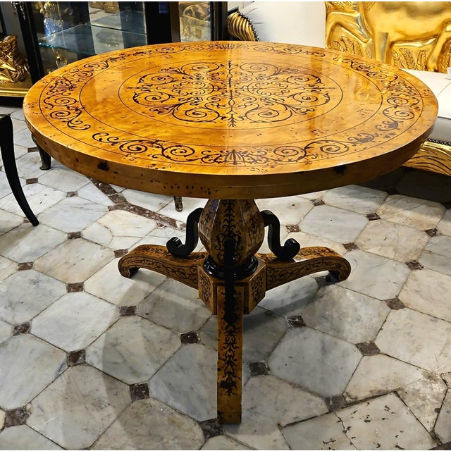 Create an impressive focal point with this grand round wood dining table, featuring a beautifully detailed tabletop with...