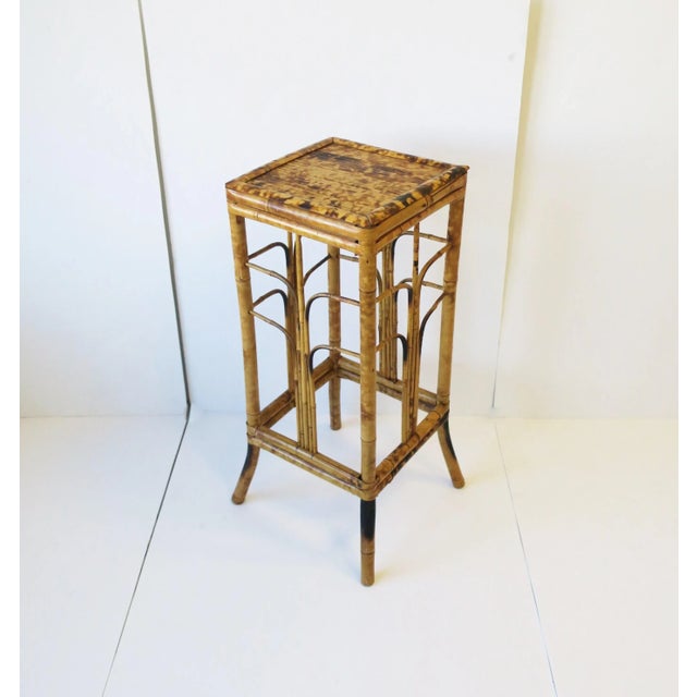 A wicker bamboo pedestal column stand table in the Art Deco Modern style, circa 1970s. A hand-crafted piece with Art Deco...