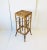 A wicker bamboo pedestal column stand table in the Art Deco Modern style, circa 1970s. A hand-crafted piece with Art Deco...