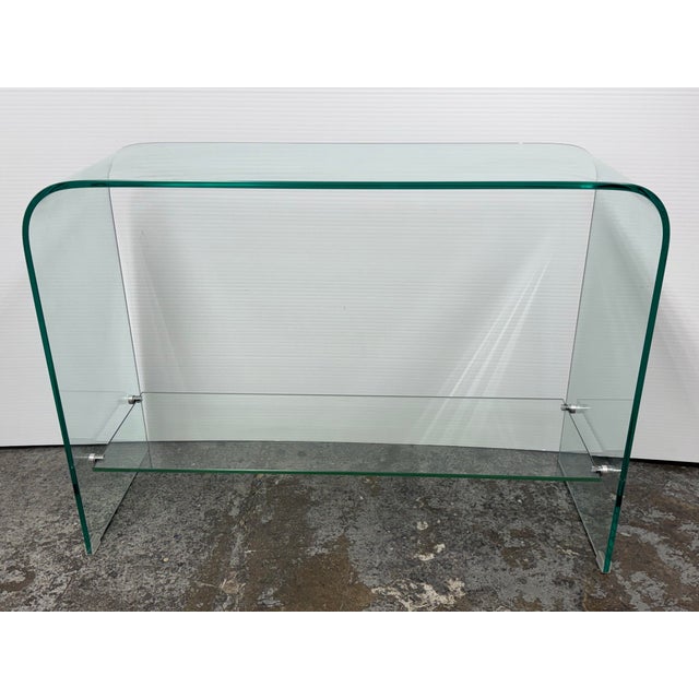 Design Plus Gallery presents the Waterfall Glass Console Table with Shelf from Orren Ellis. This contemporary design...